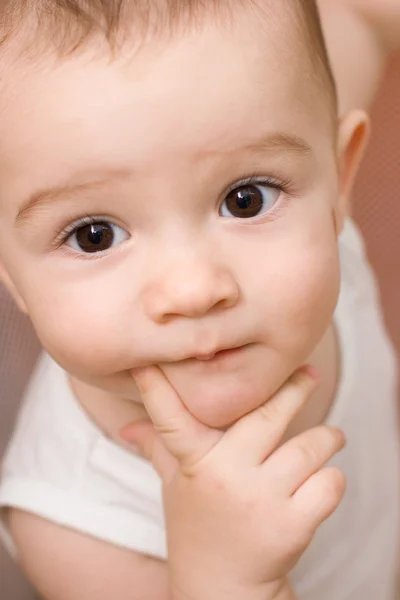Fun caucasian baby with finger in his mouth — Stock Photo, Image