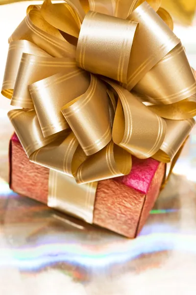 Boîte cadeau rouge sur fond doré — Photo