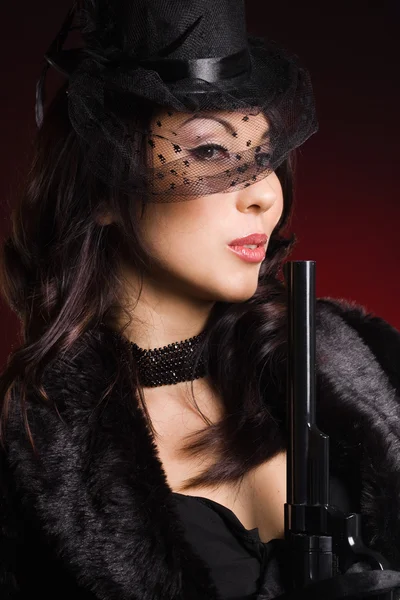 Elegant lady with a pistol in hands — Stock Photo, Image