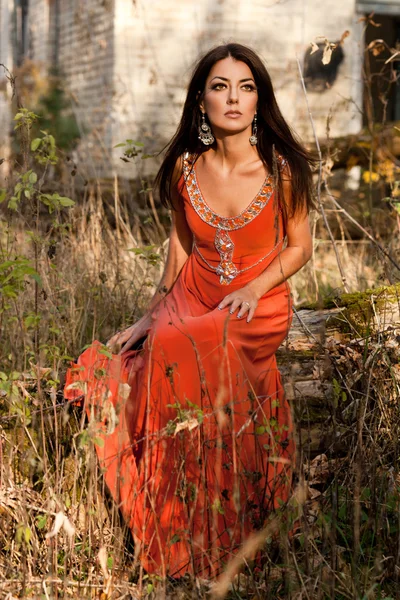 Woman in orange dress at the nature — Stock Photo, Image