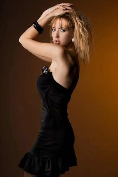 Beautiful fashionable woman in black dress — Stock Photo, Image