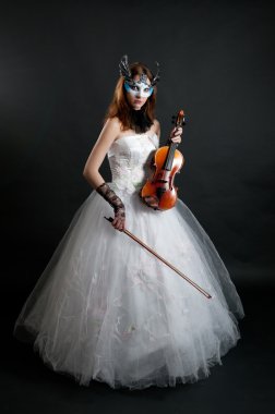 Girl in white dress and mask with violin on black background clipart