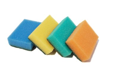 Multicolored sponges for washing dishes. Closeup, isolated on a white background. clipart