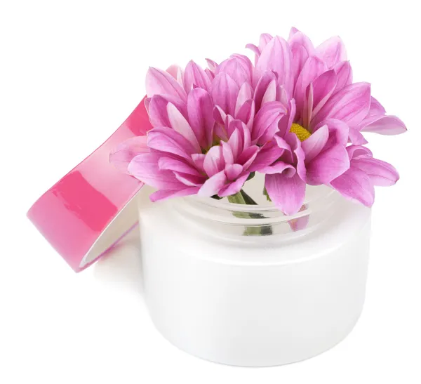 Flowers in cosmetic bottle isolated — Stock Photo, Image