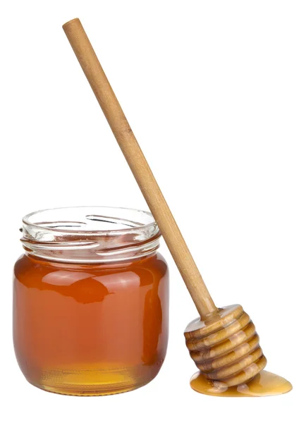 Honig in Glas und Löffel isoliert — Stockfoto