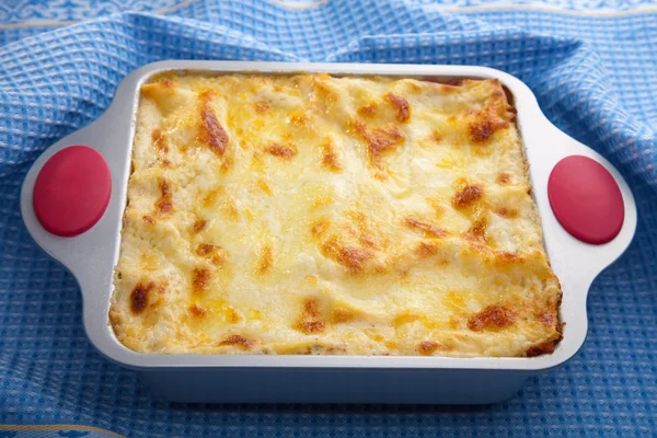 Classic lasagna over blue cloth — Stock Photo, Image