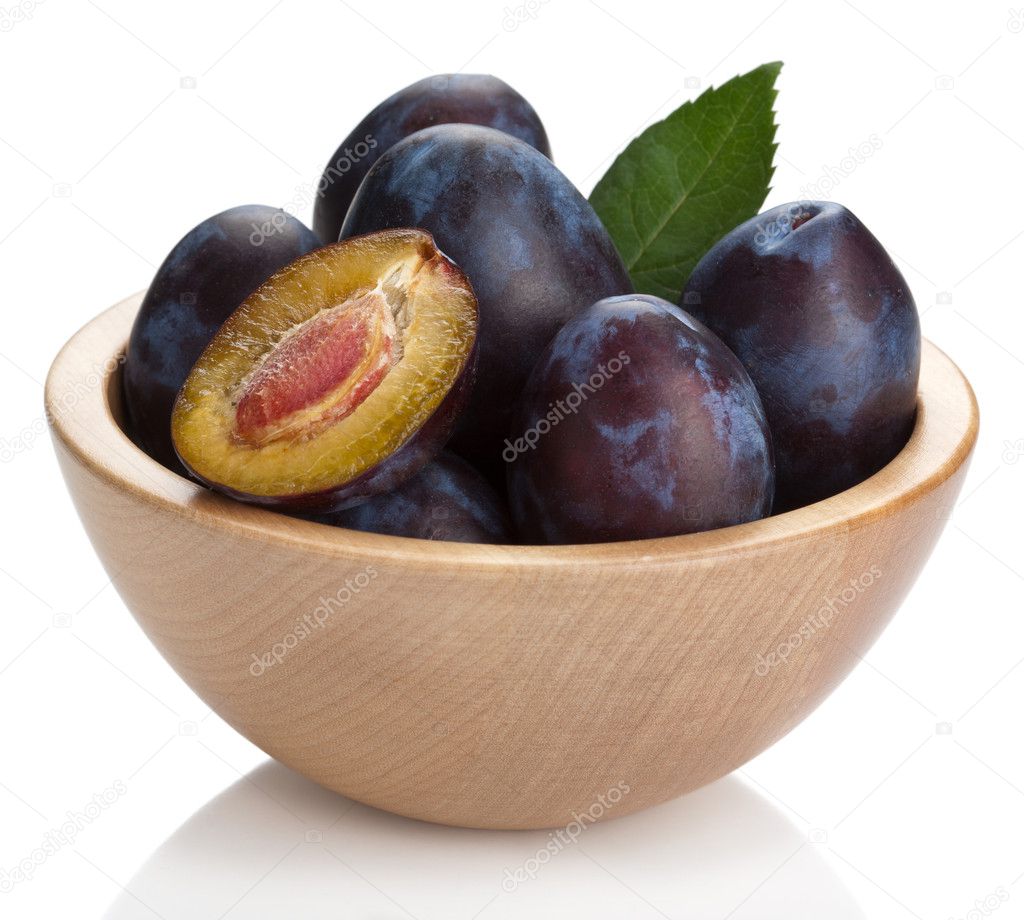Fresh plums in bowl isolated