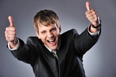 Happy businessman showing his thumbs up with smile clipart