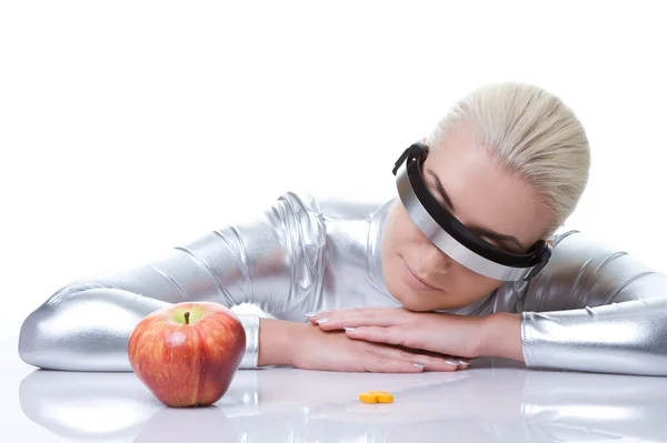 Cyber woman choosing between red apple and pills — Stock Photo, Image