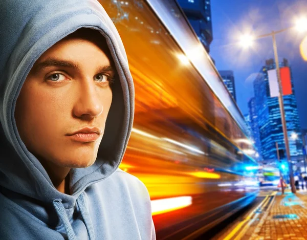 Handsome young men behind night city — Stock Photo, Image