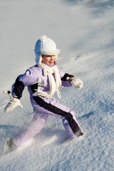 Funny little girl running in the snow — Stock Photo, Image