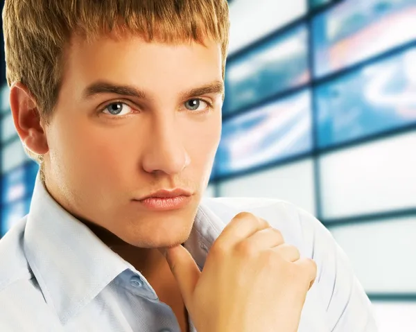 Handsome young business man over abstract background — Stock Photo, Image