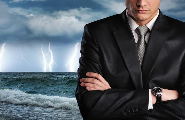 Businessman over datk stormy sky — Stock Photo, Image
