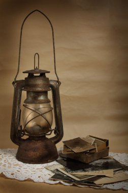 Old kerosene lamp and photos clipart