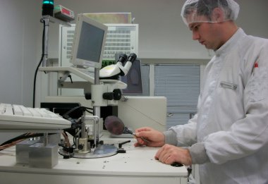 The operator of the measuring station with the silicon wafer clipart