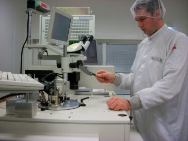 The operator of the measuring station with the silicon wafer clipart