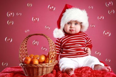 Funny Child in a Christmas red cap clipart