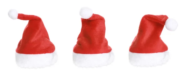 Три Santa Hat изолированы на белом фоне — стоковое фото