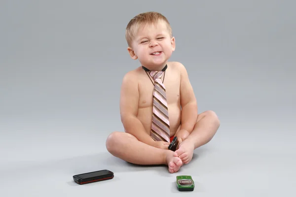 Little boy in tie speaks with cell phone — Stock Photo, Image