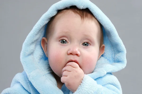 Adorable baby boy in a blue bathrobe — Stock Photo, Image