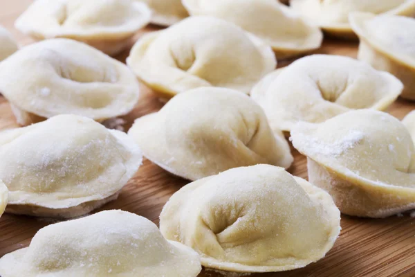 stock image Background from russian crude pelmeni laid out on a chopping board