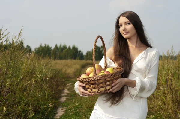 Woman with basket outdoors — Stock Photo, Image