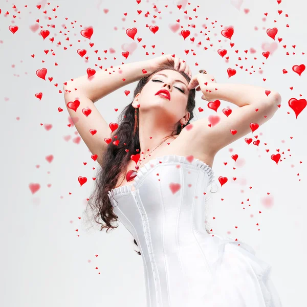 Beautiful brunette and hearts — Stock Photo, Image