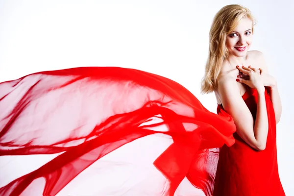 Rood, mooie blonde in een rode jurk — Stockfoto