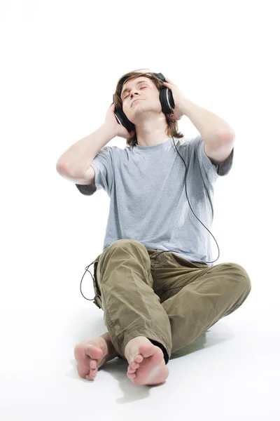 stock image Young man listening music