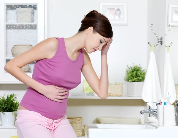 Pregnant woman with strong pain of stomach and nausea — Stock Image Pregnant woman with strong pain of stomach and nausea Stock Image