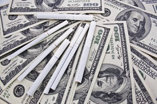 Dollars and cigarettes — Stock Photo, Image
