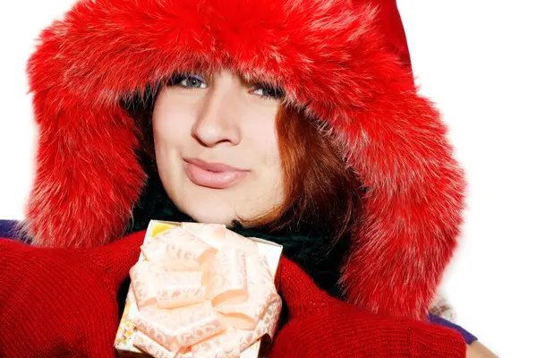 Portrait of a smiling young christmas woman giving a gift — Stock Photo, Image
