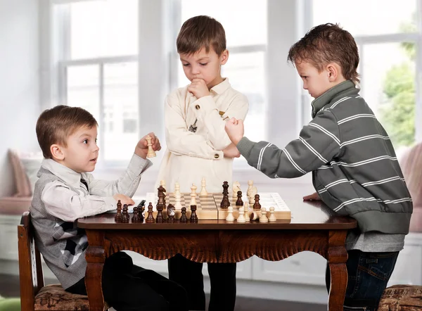 Twin brothers playing chess game — Stock Photo, Image