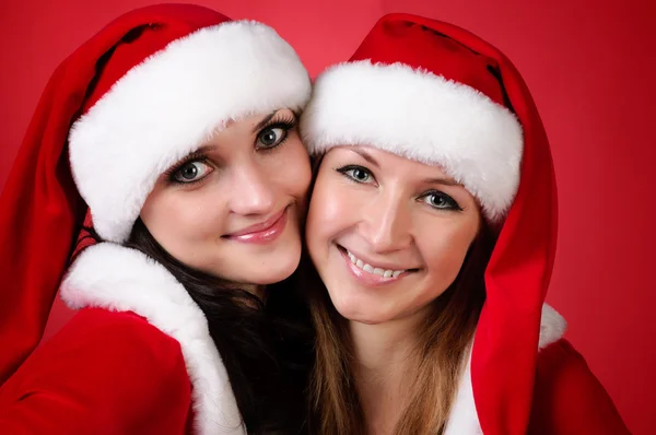 Dva přátelé dívka vánoční kostýmy na bílém pozadí. — Stock fotografie