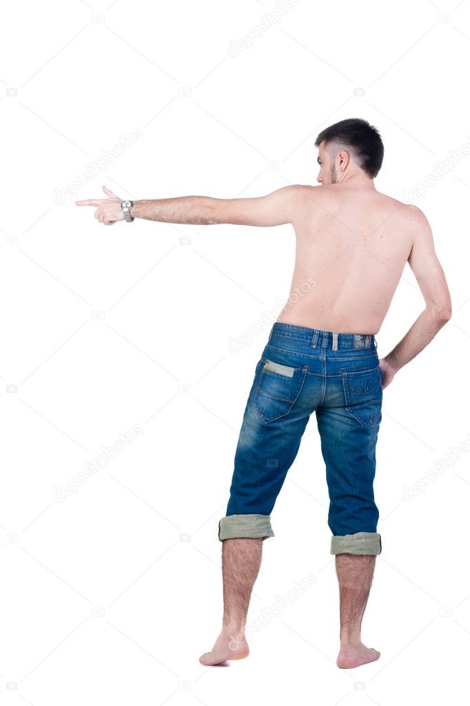 Seminude young man in jeans pointing. rear view.