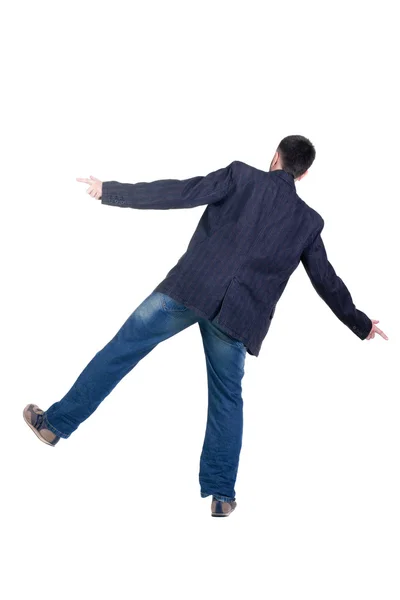 Vyvažování mladý muž v saku. zadní pohled. — Stock fotografie