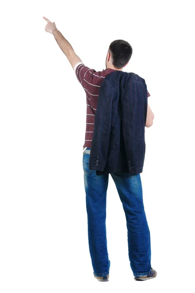 若い男が壁で指します 背面ビュー 白で隔離 — ストック写真