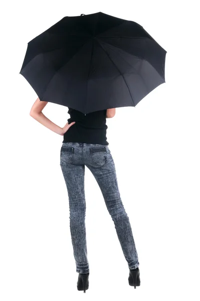 Loira jovem sob um guarda-chuva. vista traseira. — Fotografia de Stock