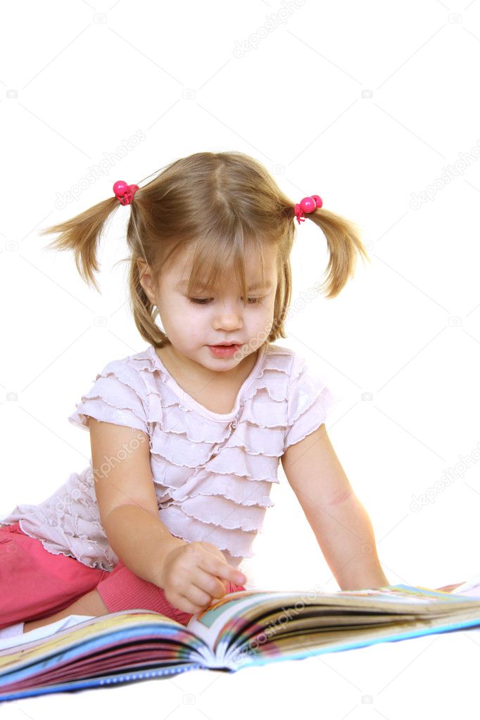 Cute little girl reading book