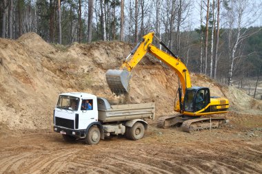 Backhoe loader loading dumper clipart