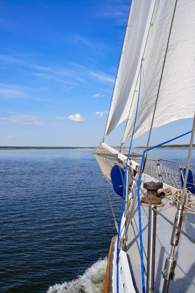 stock image Sails and a bowsprit boat against the blue sky