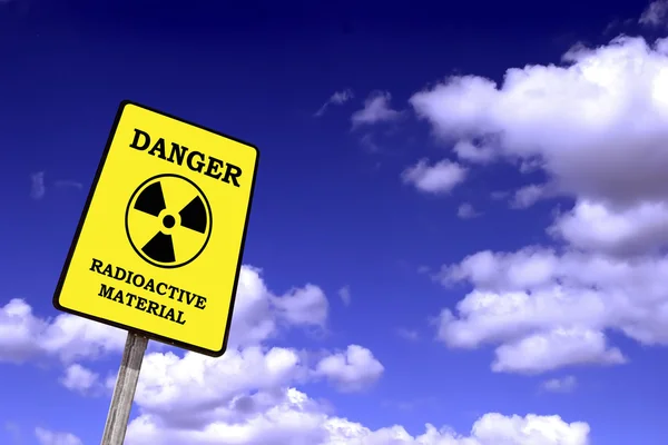 Radioactiviteit billboard op een blauwe hemel met wolken — Stockfoto