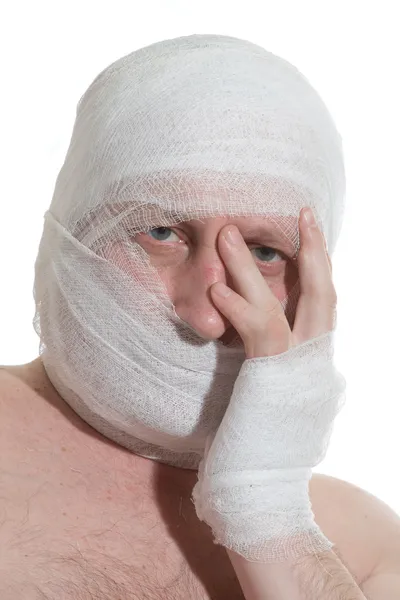 stock image Man with bandage on head. Looking unhappy at something.