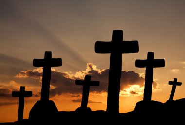 Cross silhouette and the clouds at sunset clipart