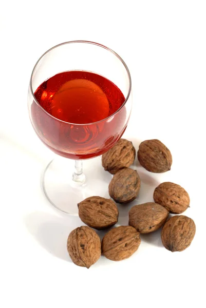 stock image Wine glass with some nuts isolated on white