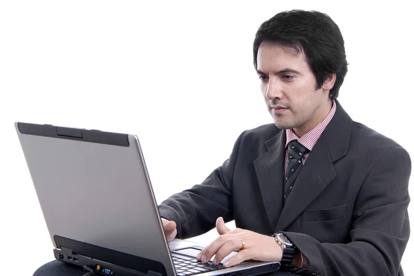 年轻的男人和与工作是笔记本电脑 免版税图库照片