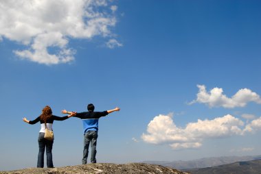 young couple in the top of the mountain clipart