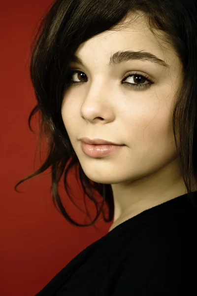 stock image Young woman portrait isolated on red background