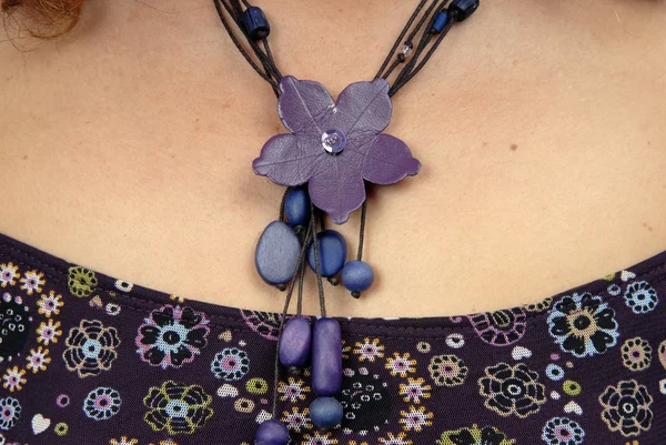 stock image Young woman chest with purple flower neckless