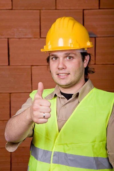 Foreman Met Gele Hoed Een Bakstenen Muur Als Achtergrond — Stockfoto